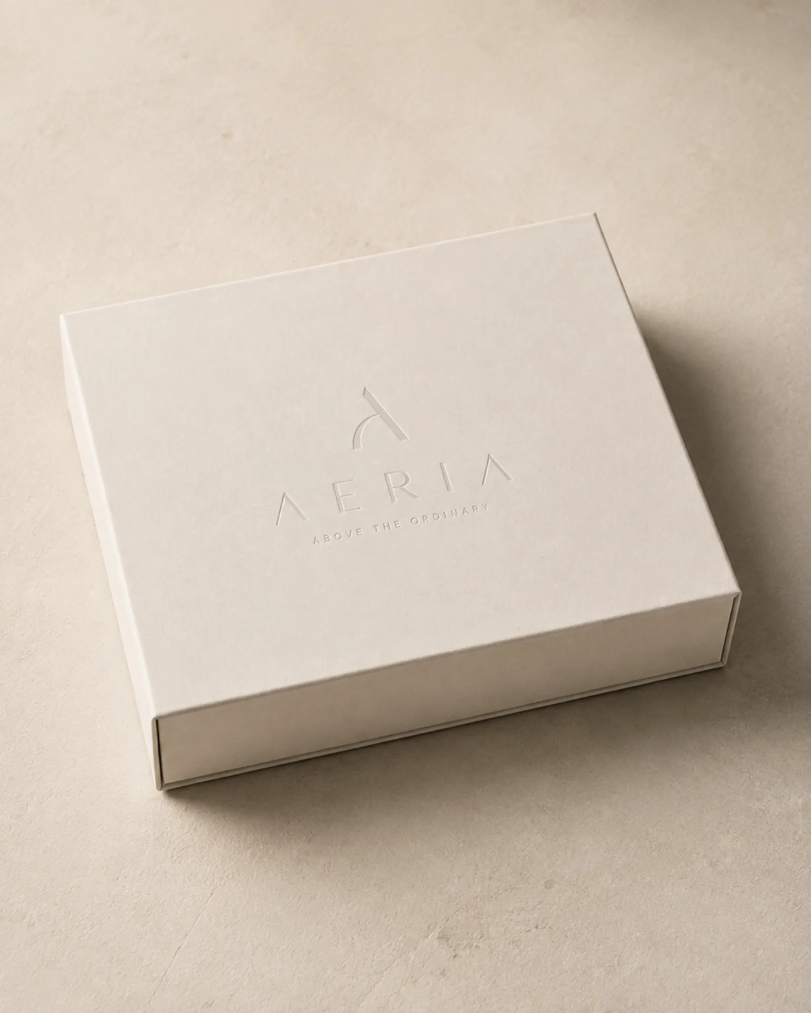 AERIA welcome box - blind-deboss monogram on uncoated stock